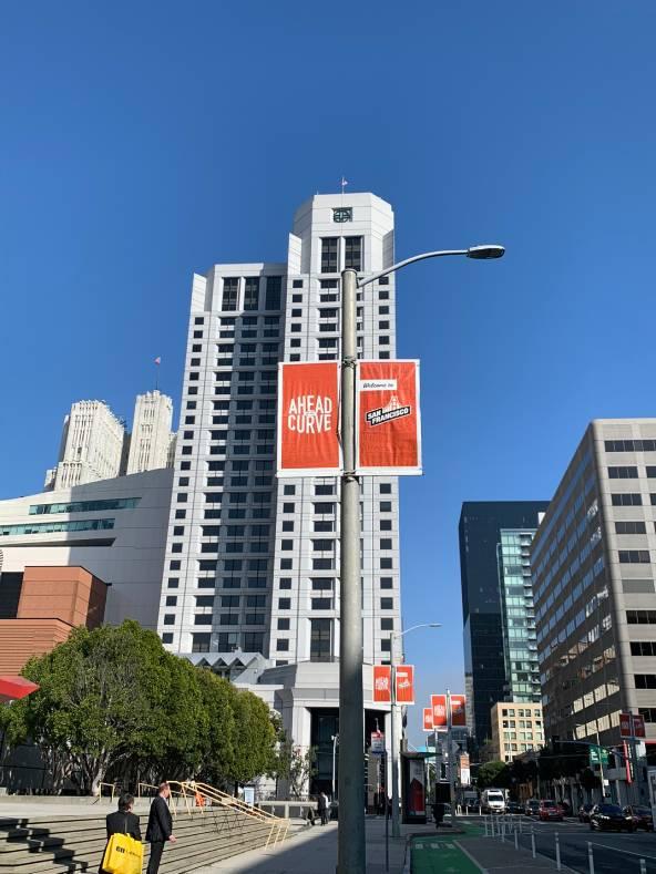 Howard Street looking toward the W Hotel with blue sky and welcome banners on lightpoles