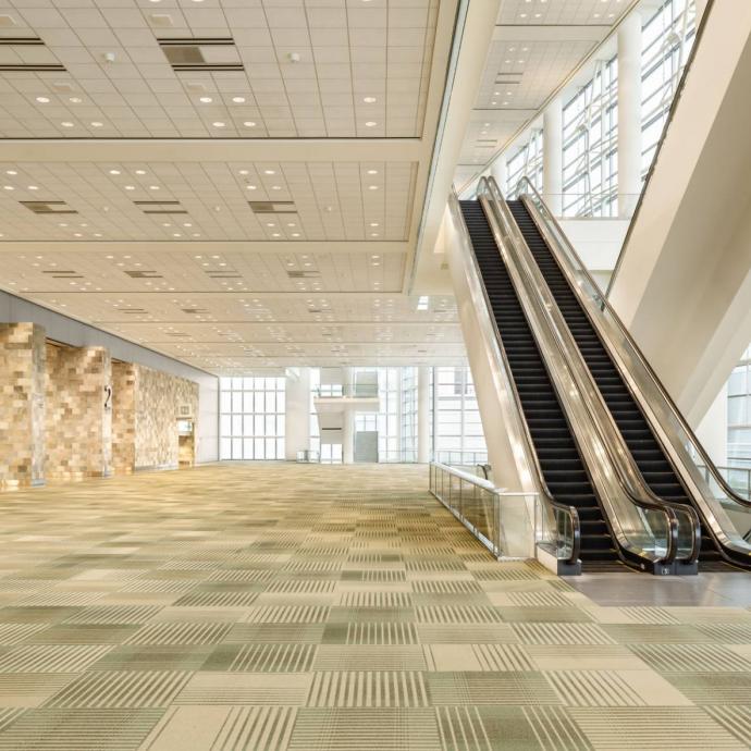 view of Moscone West lobby showing carpet and escalators, no people