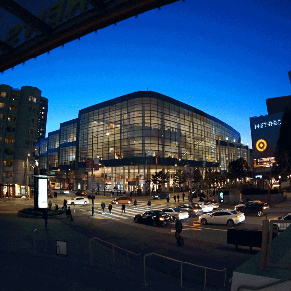 Like a lantern, Moscone West is illuminated at night.